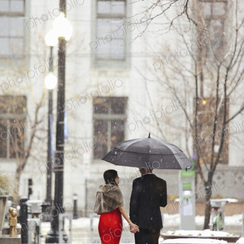 Man and woman, couple in evening dress outside in a city