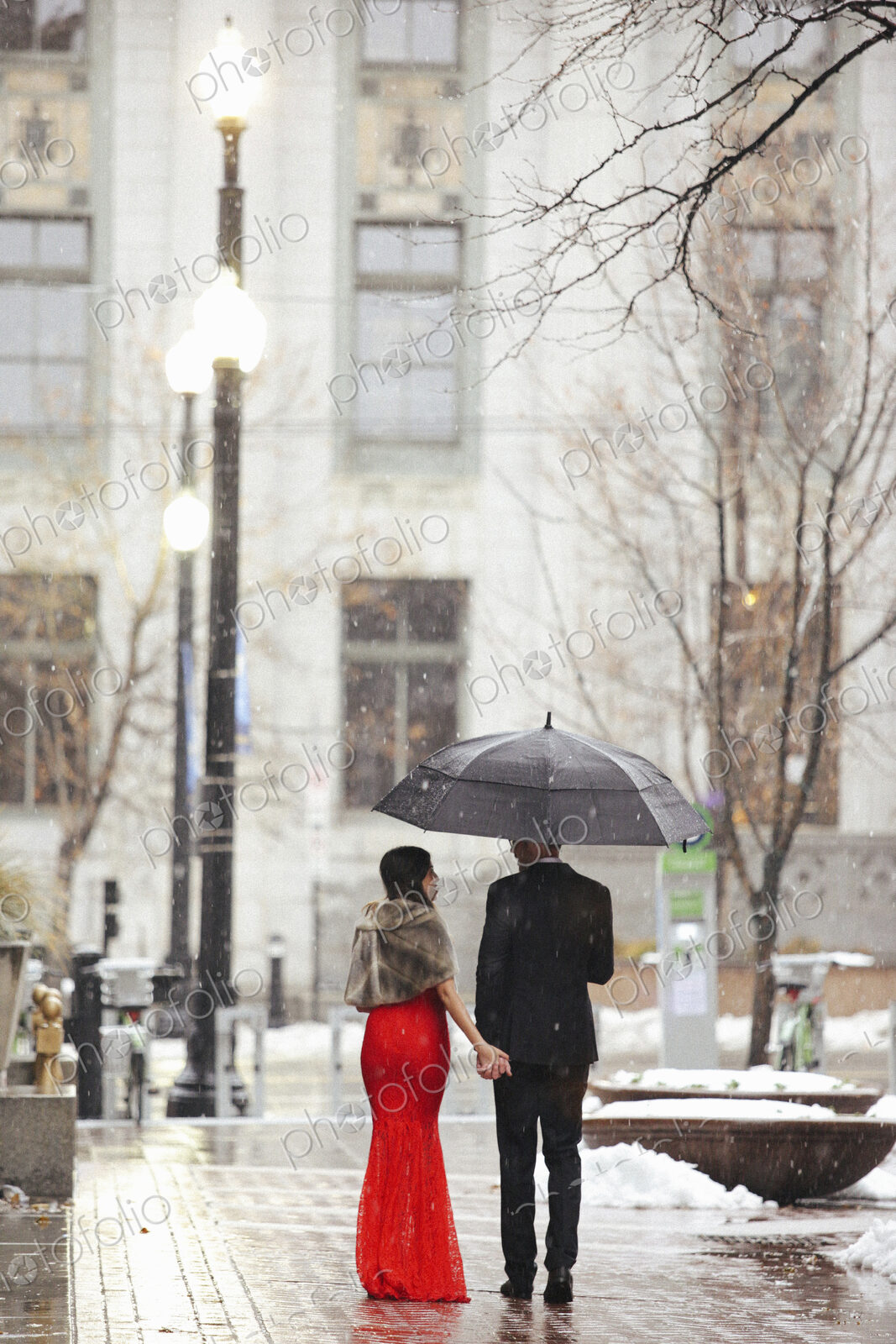 Man and woman, couple in evening dress outside in a city