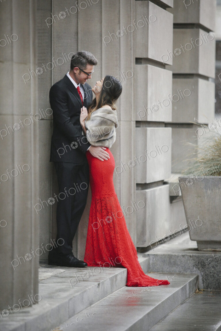 Man and woman, couple in evening dress outside in a city
