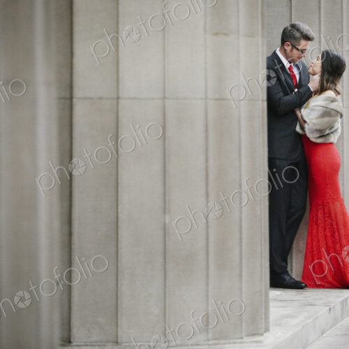 Man and woman, couple in evening dress outside in a city