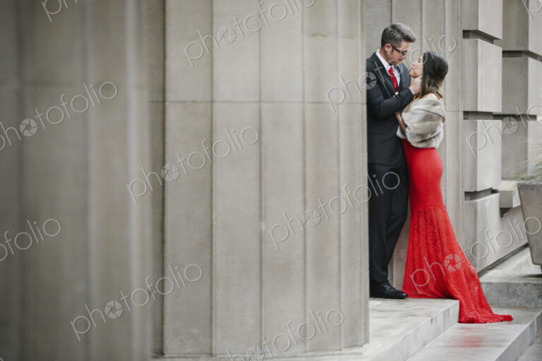 Man and woman, couple in evening dress outside in a city