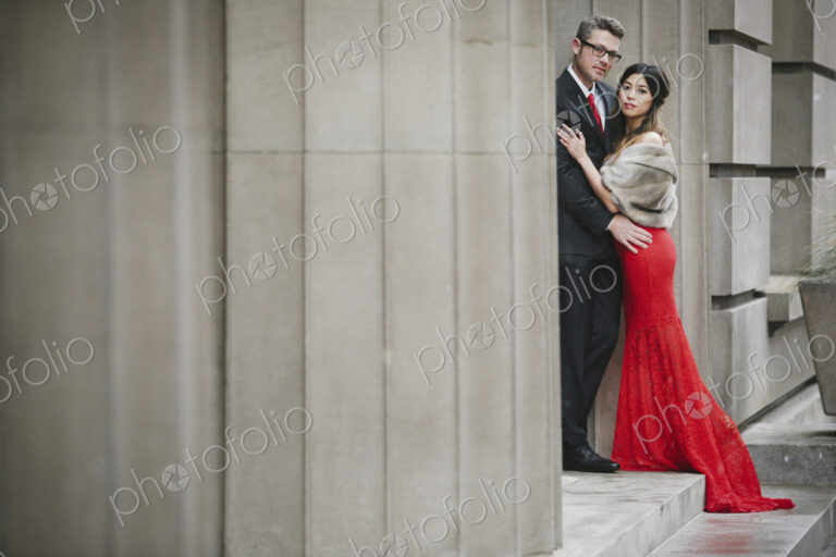 Man and woman, couple in evening dress outside in a city