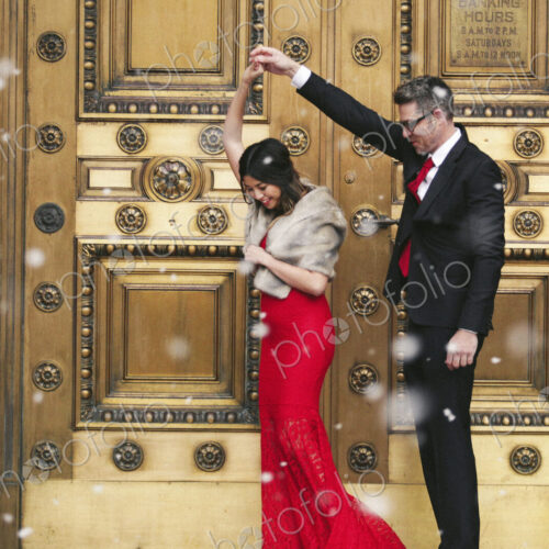 Man and woman, couple in evening dress outside in a city