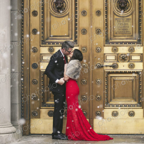 Man and woman, couple in evening dress outside in a city