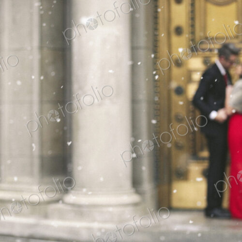 Man and woman, couple in evening dress outside in a city