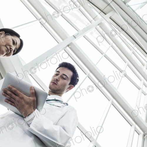 Man and woman doctors meeting to discuss a problem Man and woman doctors meeting to discuss a problem