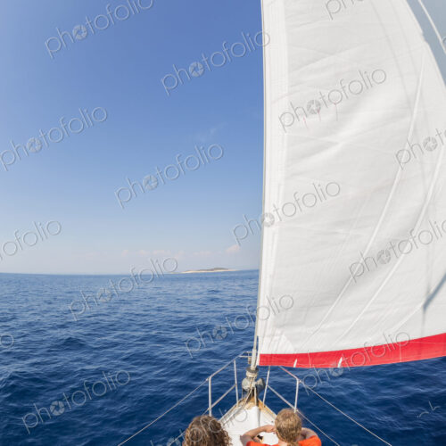 Man and woman on a sailing yacht on the Adriatic Sea.