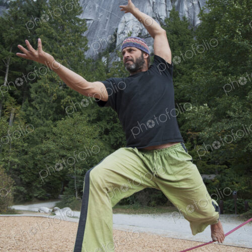 Man balancing on slack line in park Man balancing on slack line in park