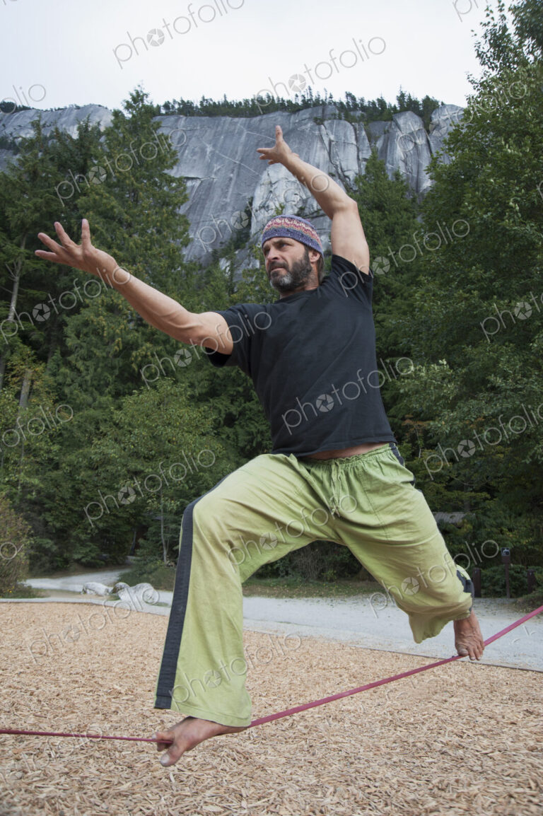 Man balancing on slack line in park