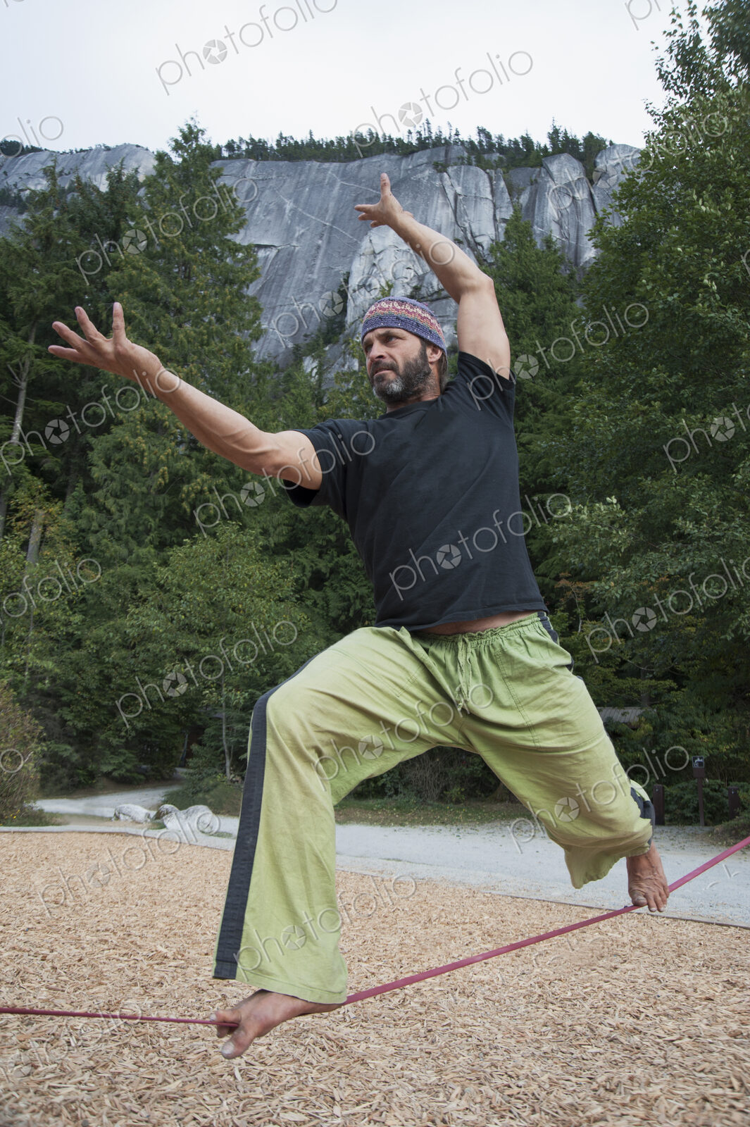 Man balancing on slack line in park