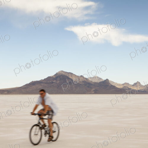 Man bicycling on Bonneville Salt Flats during Speed Week Man bicycling on Bonneville Salt Flats during Speed Week