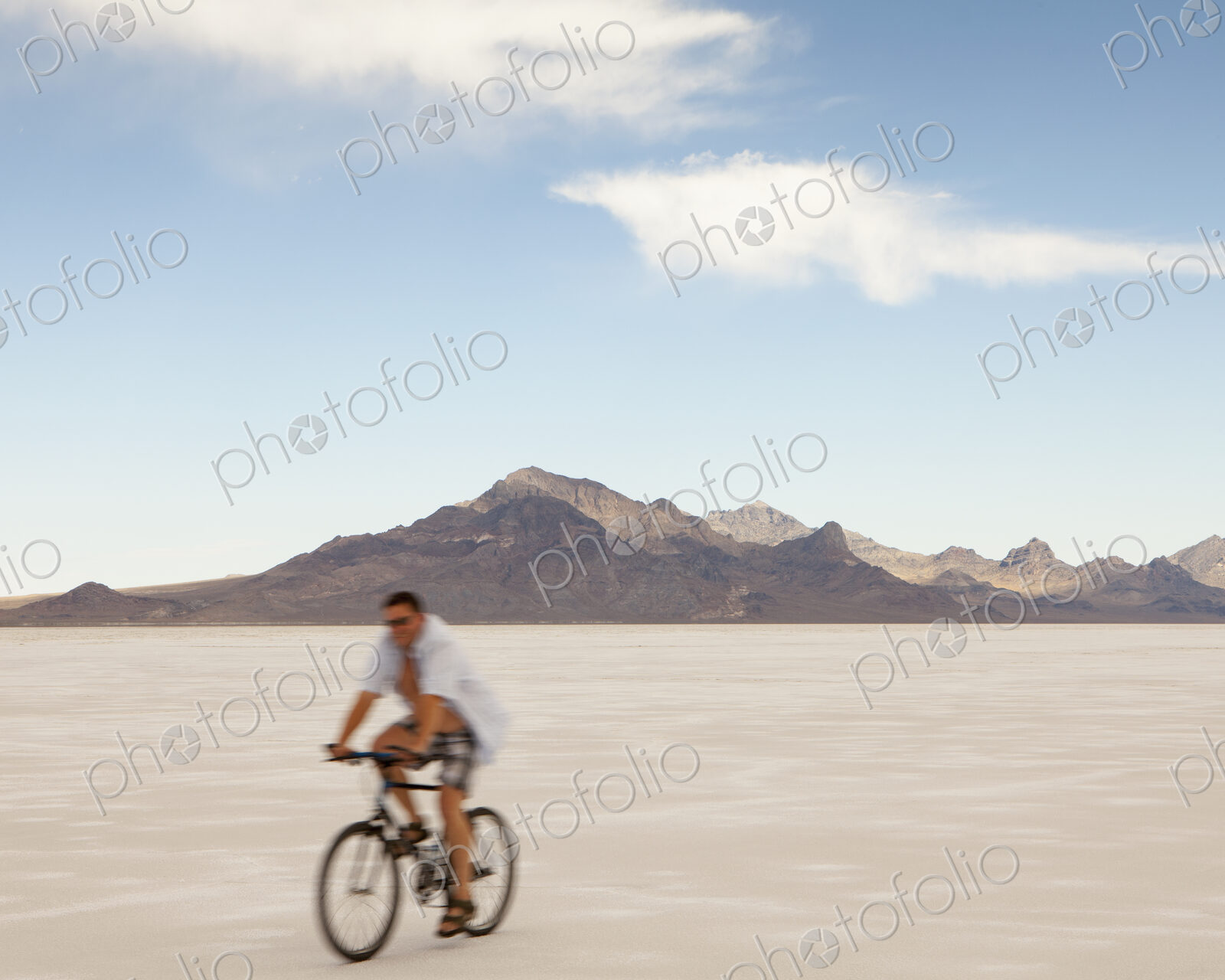 Man bicycling on Bonneville Salt Flats during Speed Week