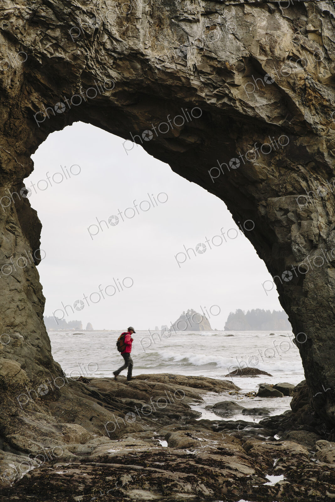 Man hiking on the beach at Hole-in-the-Rock on Rialto Beach