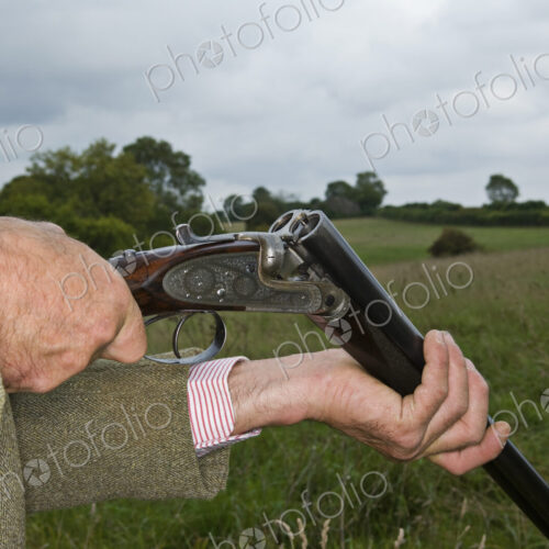 Man holding an open rifle. Man holding an open rifle.