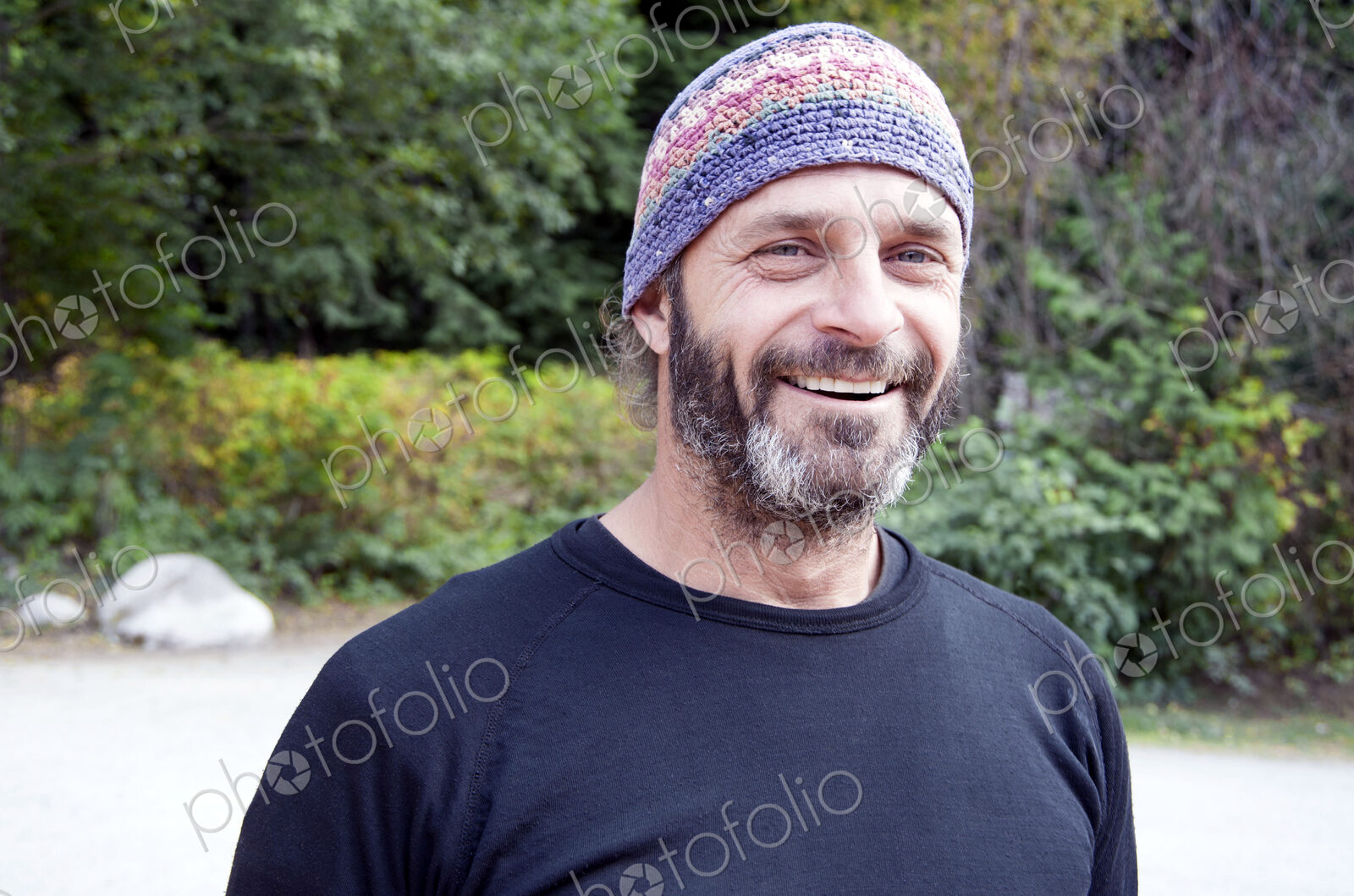 Man in rural area wearing knitted hat.