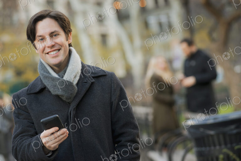 Man in urban park with smartphone