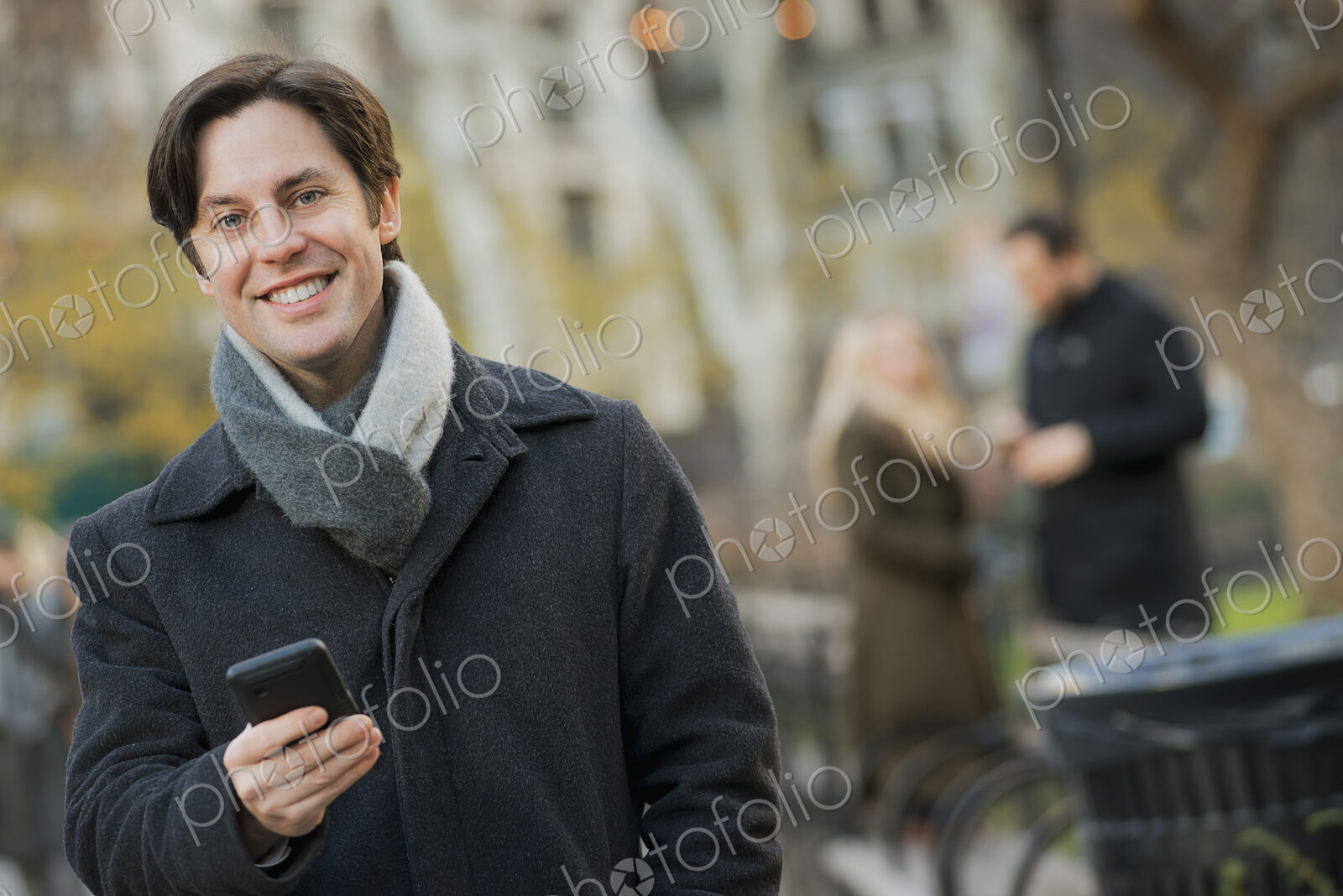 Man in urban park with smartphone