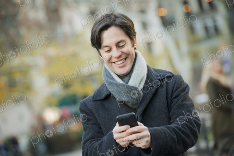 Man in urban park with smartphone