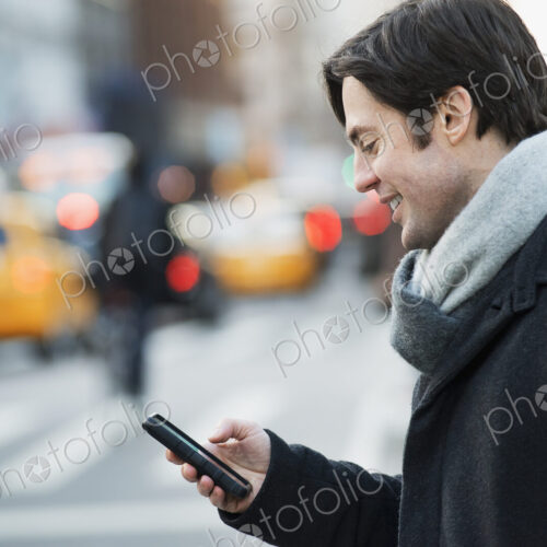 Man on busy street with smartphone Man on busy street with smartphone