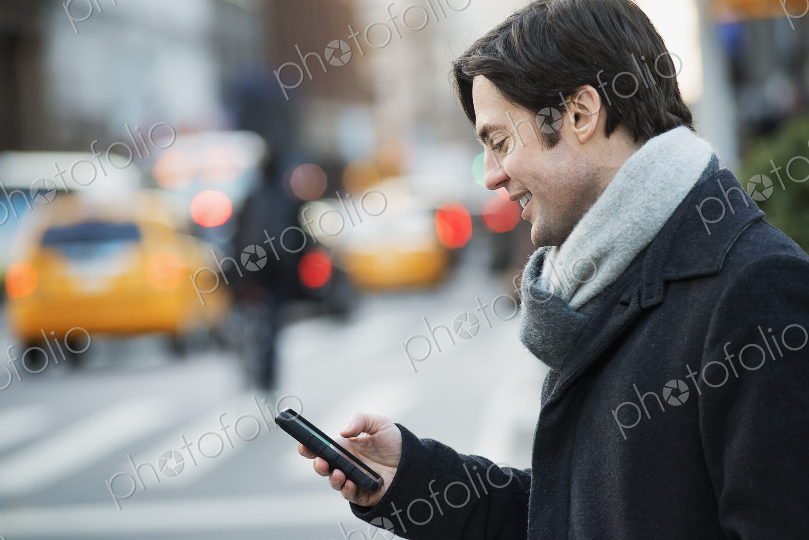 Man on busy street with smartphone