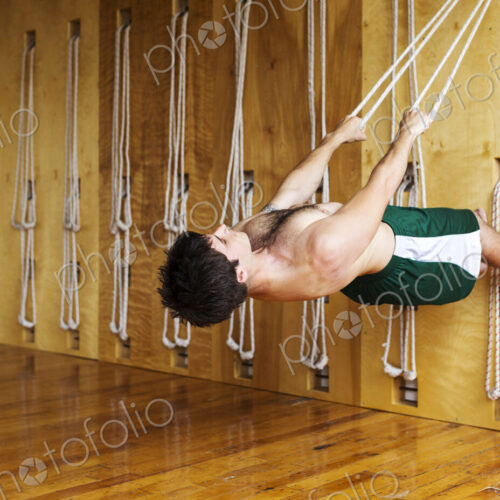 Man practicing acro yoga in studio