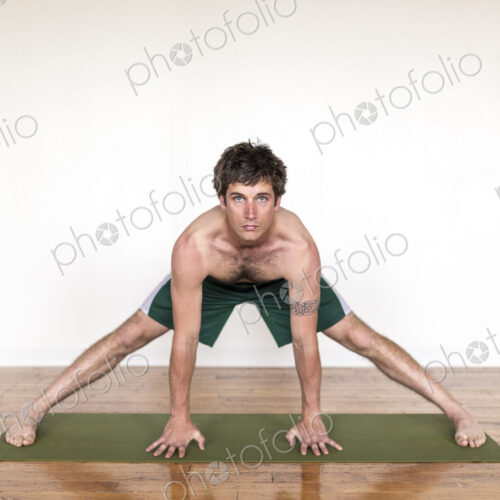 Man practicing yoga in studio