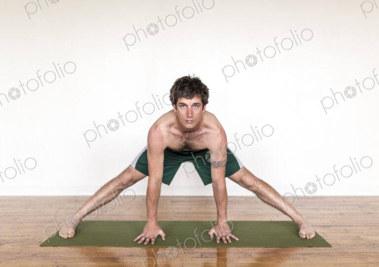 Man practicing yoga in studio