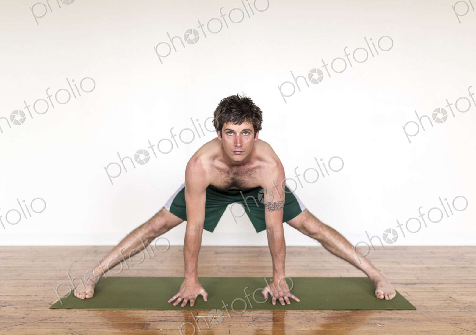 Man practicing yoga in studio
