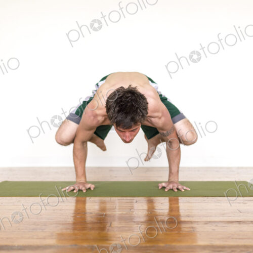 Man practicing yoga in studio