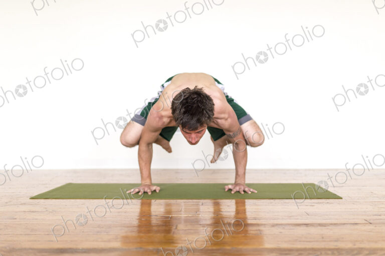 Man practicing yoga in studio