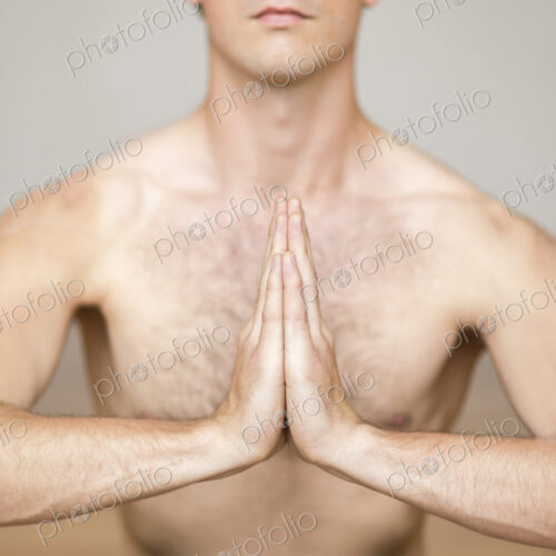Man practicing yoga in studio