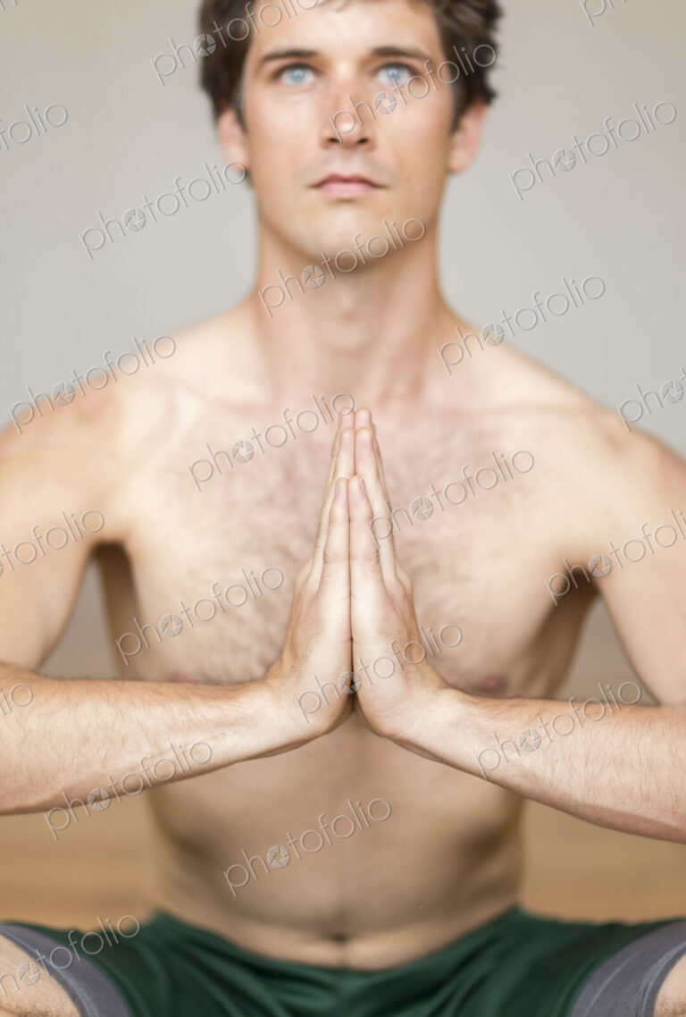Man practicing yoga in studio