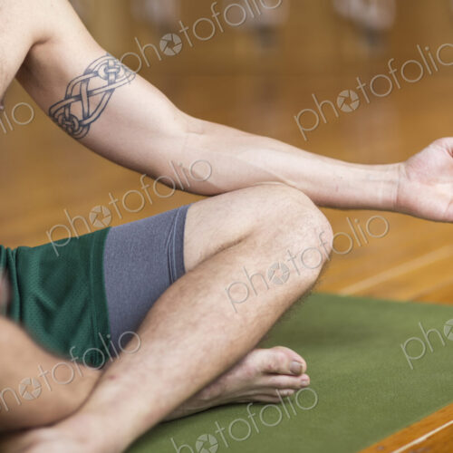 Man practicing yoga in studio Man practicing yoga in studio