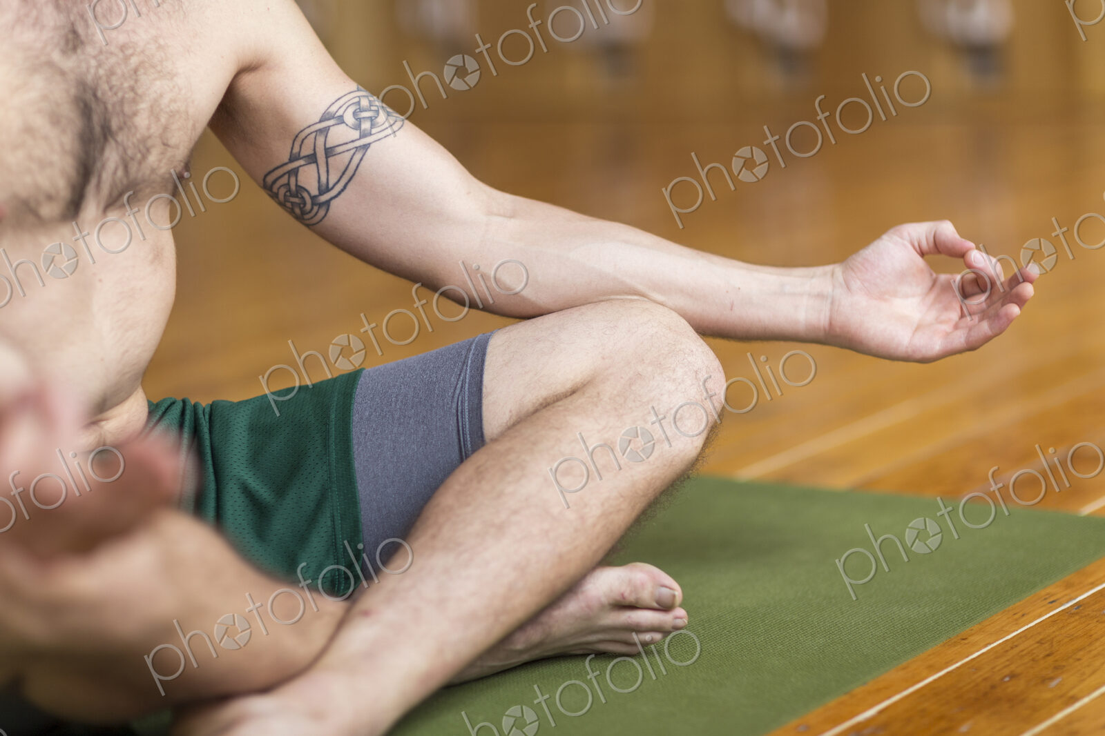 Man practicing yoga in studio