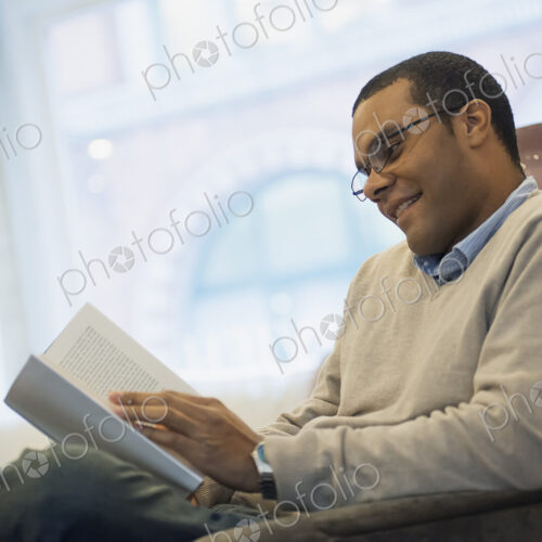 Man relaxing at home reading