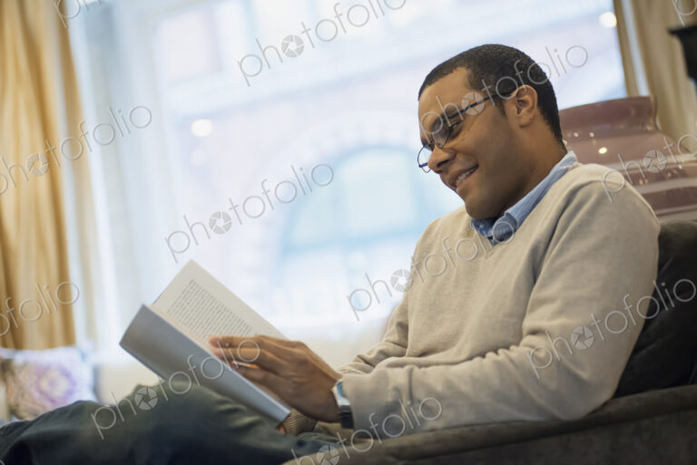 Man relaxing at home reading