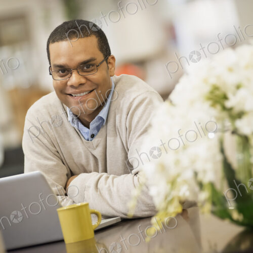 Man relaxing at home with laptop