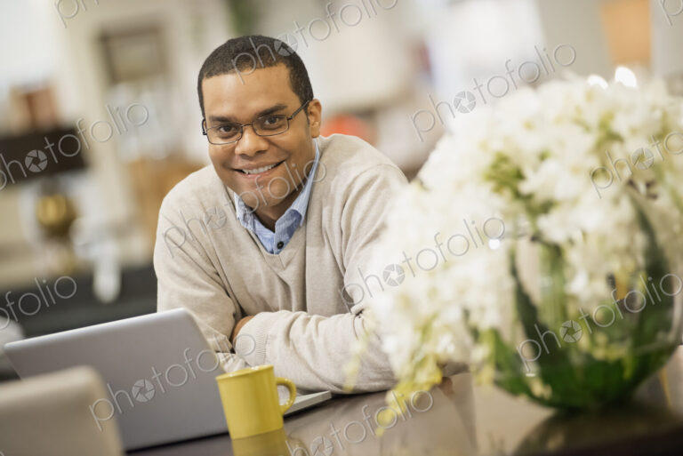 Man relaxing at home with laptop