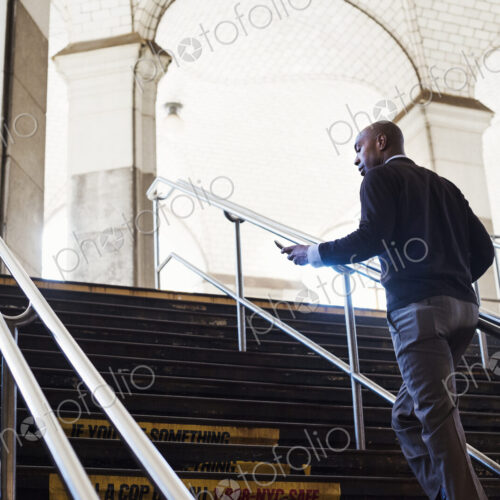 Man running up the steps at a subway station in New York City Man running up the steps at a subway station in New York City