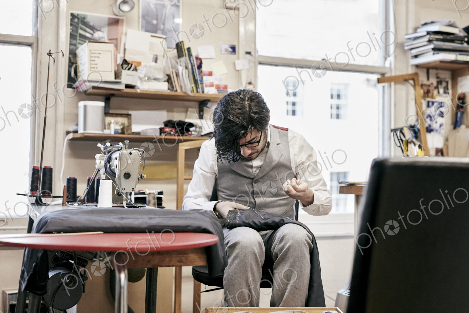 Man sewing suit by hand in family tailor business