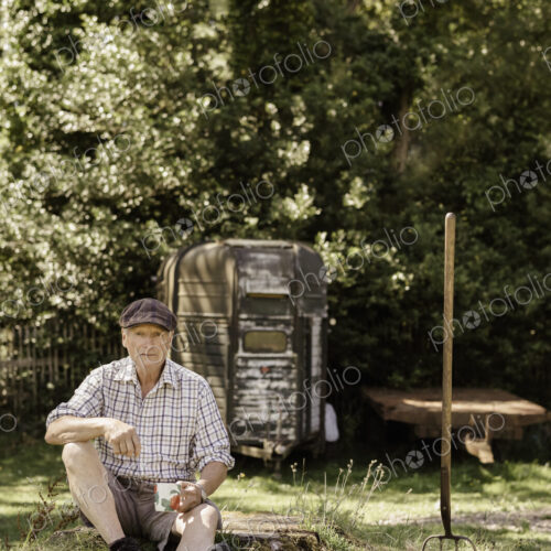 Man sitting in a garden.