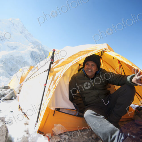 Man sitting in base camp tent, Everest, Khumbu glacier, Nepal Man sitting in base camp tent, Everest, Khumbu glacier, Nepal