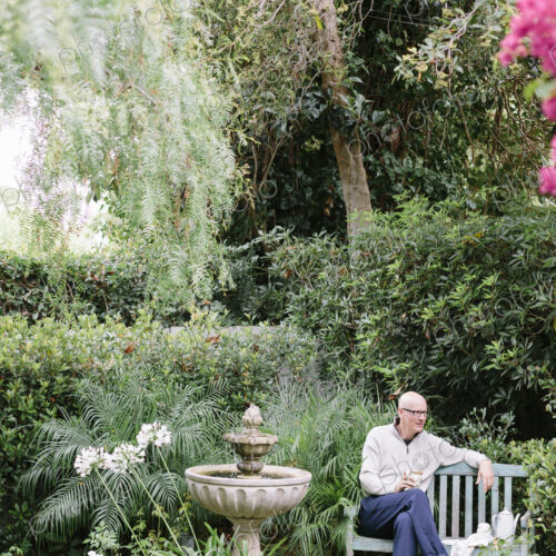Man sitting on a wooden bench in a garden, taking a break. Man sitting on a wooden bench in a garden, taking a break.