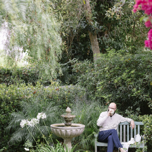 Man sitting on a wooden bench in a garden, taking a break. Man sitting on a wooden bench in a garden, taking a break.
