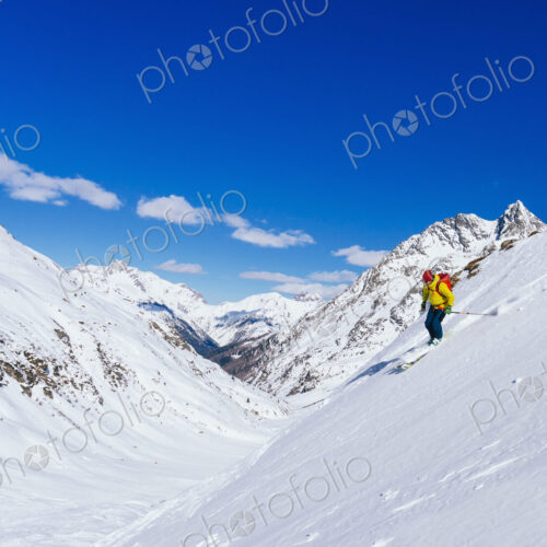 Man skiing on snowy slope in remote landscape