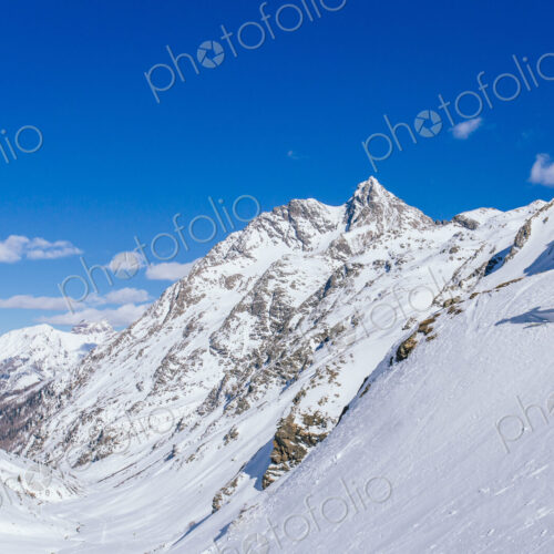 Man skiing on snowy slope in remote landscape