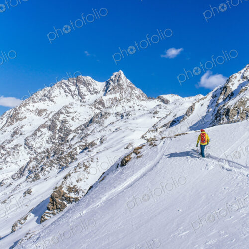 Man skiing on snowy slope in remote landscape