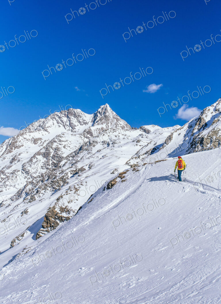 Man skiing on snowy slope in remote landscape