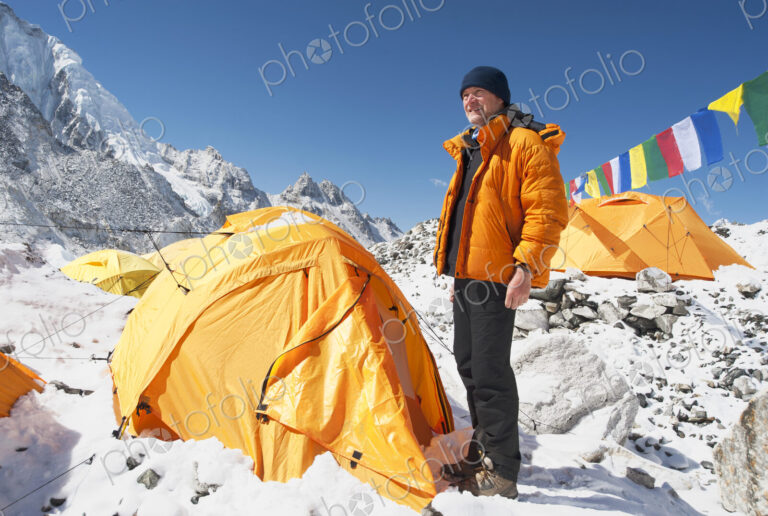Man standing at base camp tent