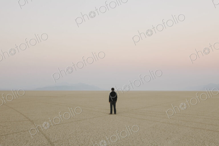 Man standing in vast, desert landscape